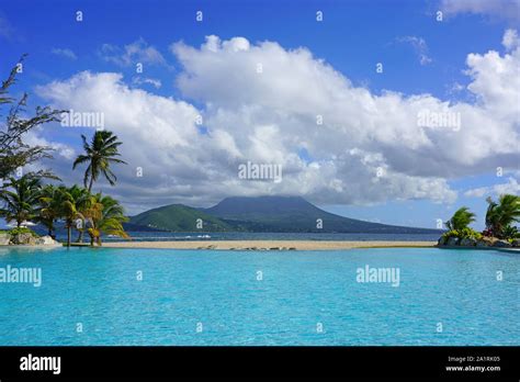 Day view of the Nevis Peak volcano across the water from St Kitts Stock Photo - Alamy