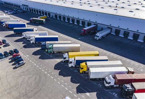 Aerial Shot Of Industrial Warehouse Area Where Many Trucks Are Loading Merchandise Stock Photo ...