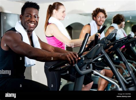 Group of smiling people at the gym doing cardio exercise Stock Photo - Alamy