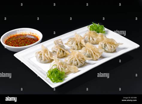 Fried dumplings with sauce Stock Photo - Alamy