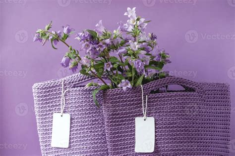 Two purple handmade knitted bag with flowers on a purple and light blue ...