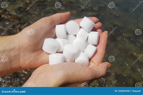 Salt Pellets for the Water Softener. Salt in Female Hands. Stock Photo ...