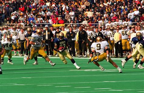 A U.S. Naval Academy football player advances the ball forward during the annual Army-Navy ...