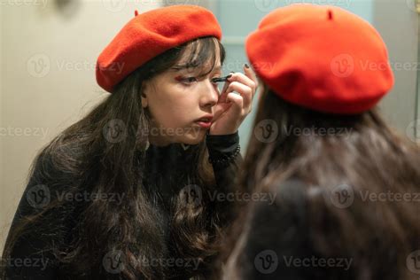 Young elegant girl doing her makeup with eyeliner 14003749 Stock Photo at Vecteezy