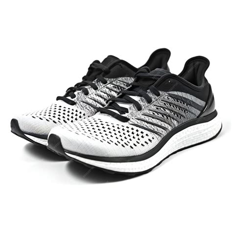 Premium Photo | Pair of black and white running shoes isolated on white ...