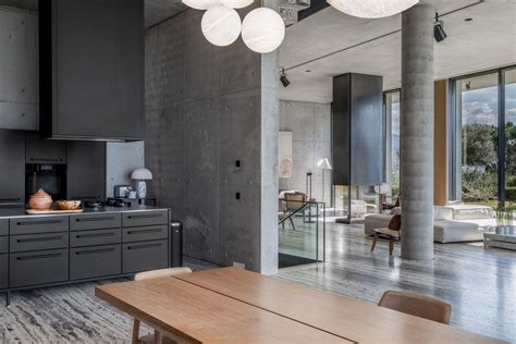 This brutalist home features a dramatic matte black kitchen | Livingetc