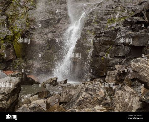 Close up for waterfall Fossa (Fossá) during strong wind in rainy weather, Streymoy Island, Faroe ...