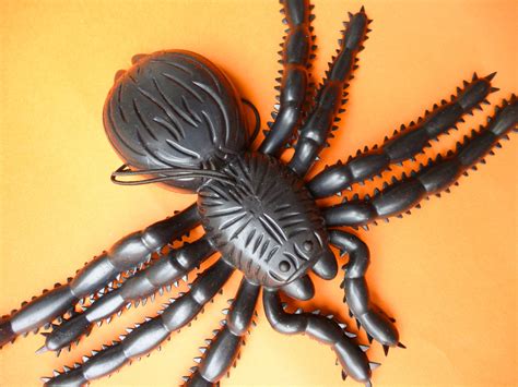 Image of Plastic spider toy on orange background | CreepyHalloweenImages