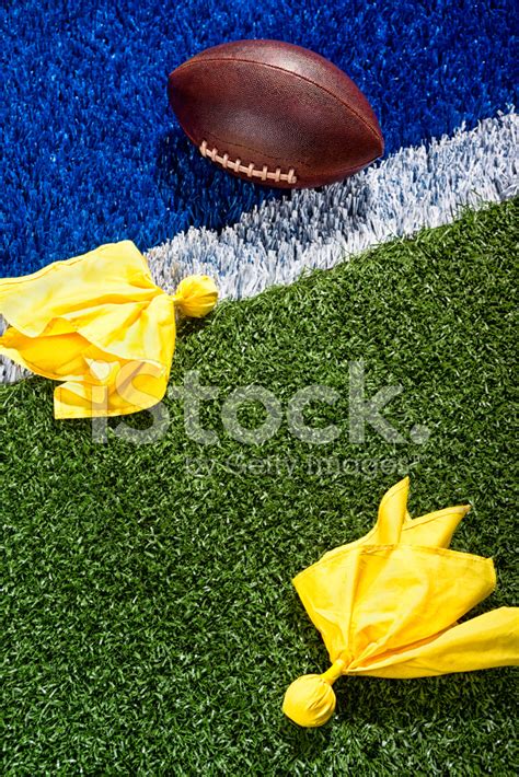 Penalty Flags Around A Football At The End Zone. Stock Photo | Royalty ...