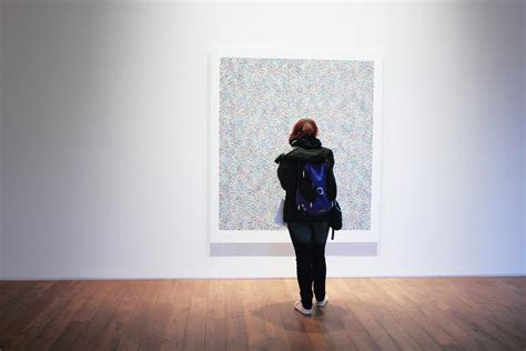 Woman Standing Infront of a Wall Mount Painting · Free Stock Photo