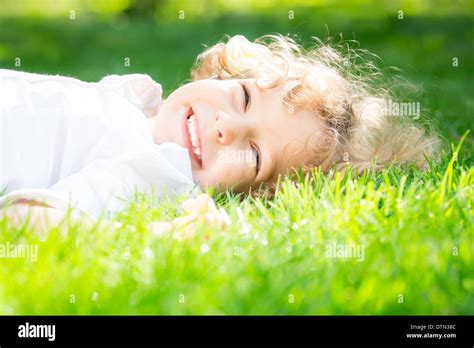 Child lying on grass Stock Photo - Alamy