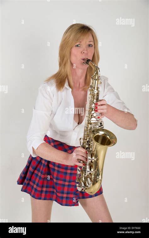 Portrait of a woman playing an Alto saxophone Stock Photo - Alamy