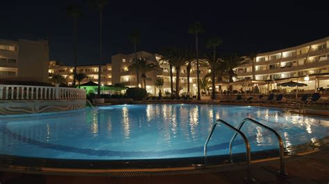 Resort scene with a pool at night 28596878 Stock Video at Vecteezy