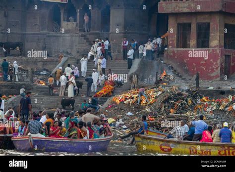 Cremation of bodies, on the burning ghat, on the banks of Ganges river ...