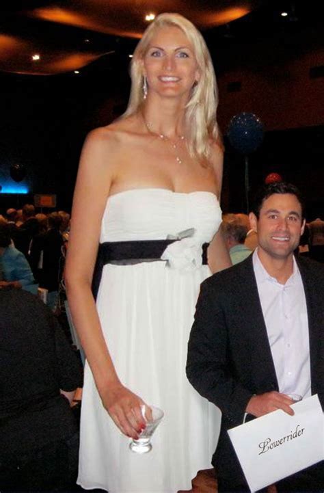 a woman in a white dress standing next to a man