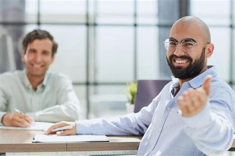 Premium Photo | Interview in the office two young men smile