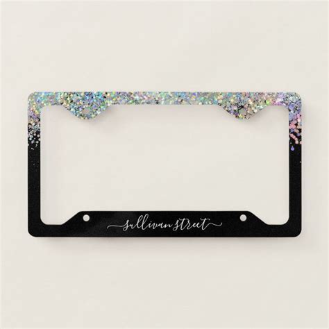 a black license plate frame with glitter on the bottom and name written ...