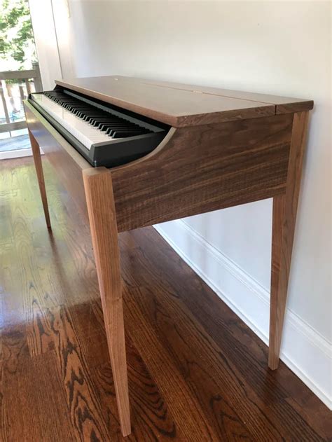 I made a Walnut keyboard stand. The top flips open and has a shelf for music books. It closes ...