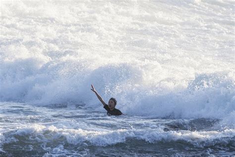 Dramatic moment drowning swimmer is saved by lifeguards after getting caught in rip current on ...