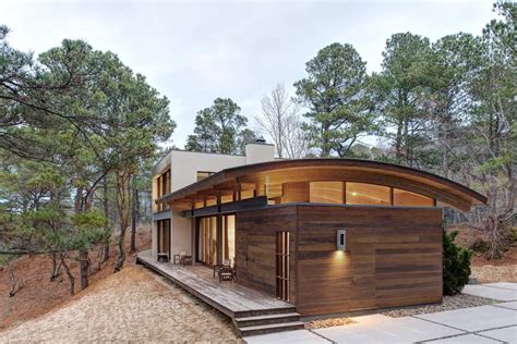 Contemporary Forest House with Curved Metal Roof