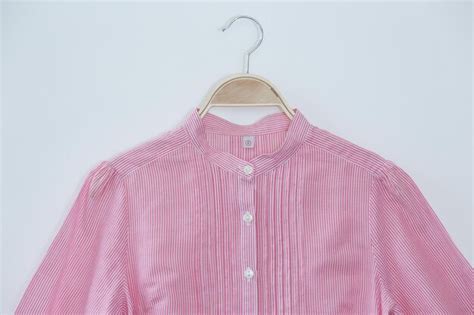 Premium Photo | Pink women shirt is clothes hanger on white background