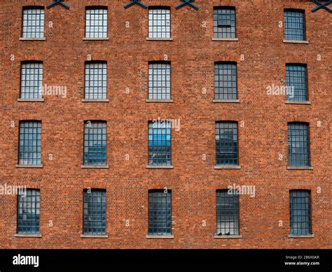 Facade / front of an old factory building made of red brick with a lot of vintage windows Stock ...