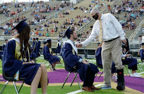 Lake Creek High School roars with pride as principal who survived COVID-19 graduates first ...