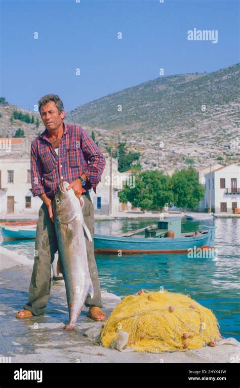 Fishing in Symi Harbour, Crete Stock Photo - Alamy