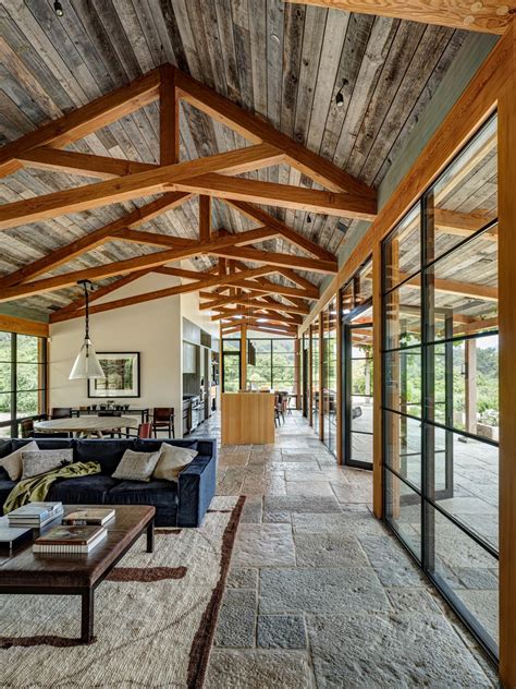 Living area with concrete flooring and ceiling paneled in reclaimed barn-wood siding, Carmel ...