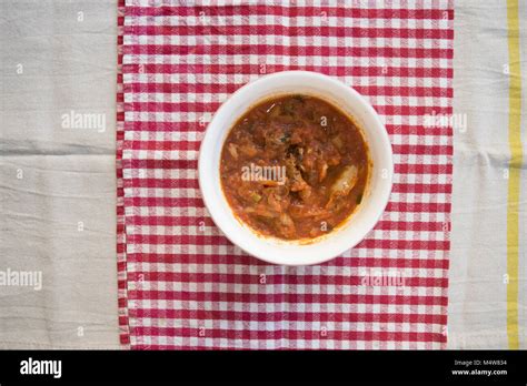 top view on a bowl with dried salted cod at livornese style Stock Photo - Alamy