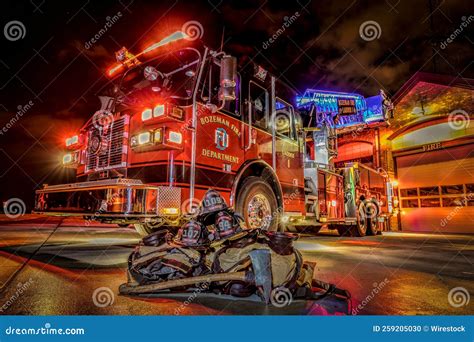 Ladder Truck and Fire Station at Night with Fire Fighters Gear ...