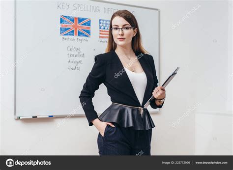 Female teacher looking at camera. English language school. Stock Photo by ©undrey 223772956