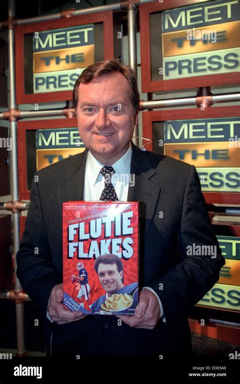 Tim Russert host of NBC's Meet the Press a fan of the Buffalo Bills holds a box of quarterback ...