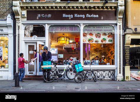 Deliveroo food delivery couriers pick up takeaway meals from the Hong Kong Fusion restaurant in ...