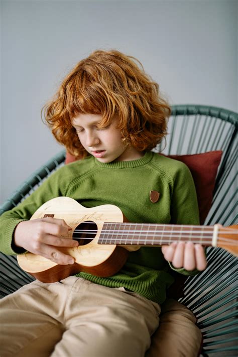 Boy Playing an Acoustic Guitar · Free Stock Photo