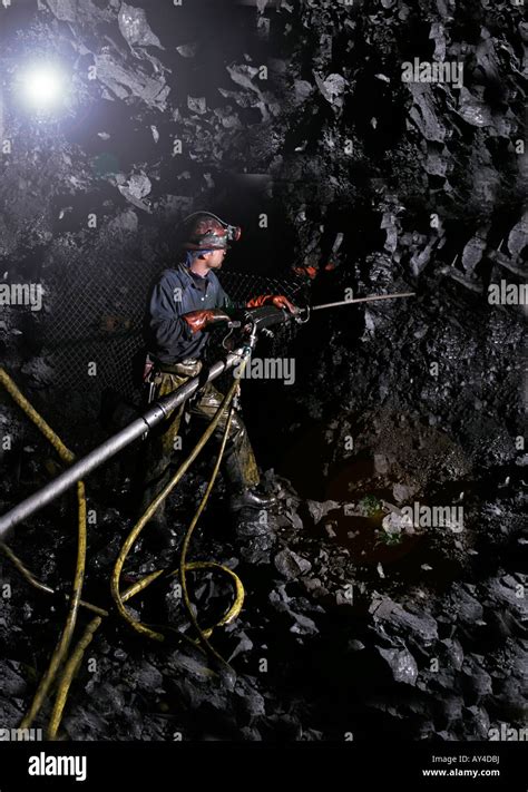 Drilling holes using jumbo drill before rock bolt installation during ...