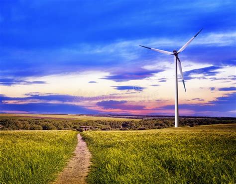 Wind turbine at sunset stock photo. Image of energy - 149449928