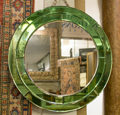 ART DECO WALL MIRROR, early 20th century circular with double green mirror marginal plate border ...