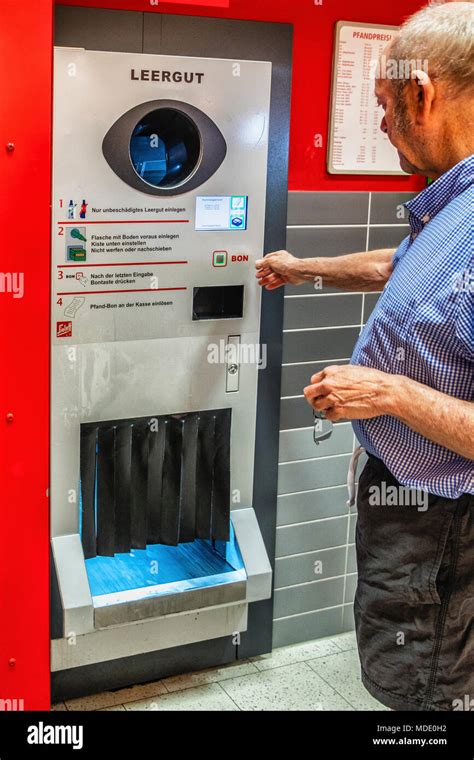 Berlin, Germany. Elderly senior man returning empty bottles to supermarket. Bottle recycling ...