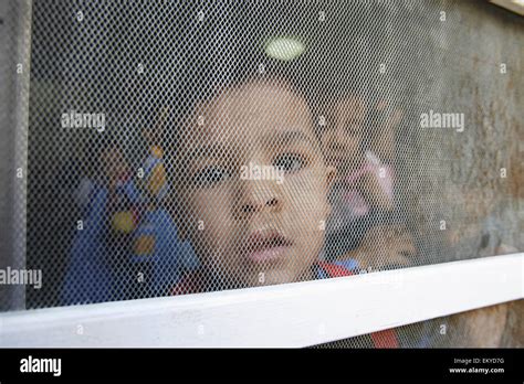 A student peers out the window at the Early Childhood Development Union; Alexandria, Egypt Stock ...