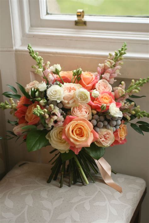 Wedding bouquet in pink and peach with roses, snapdragons, spray roses ...