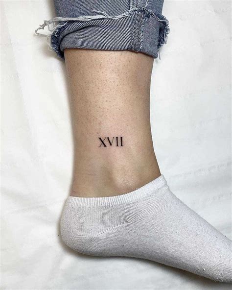 Roman numerals XVII tattoo by Conz Thomas inked on the left ankle ...