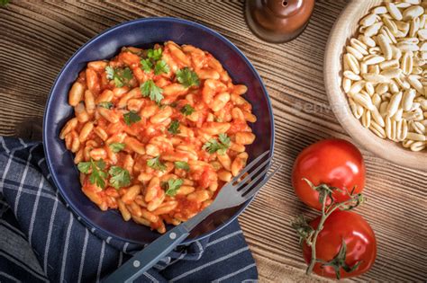 Cavatelli pasta with fresh tomato sauce. Stock Photo by foto_pstryki