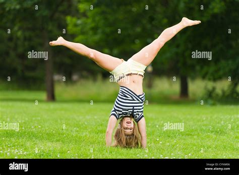 Young girl doing cartwheel at the park with narrow depth of field Stock Photo - Alamy