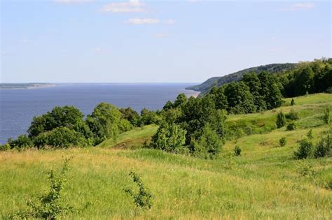 Premium Photo | Green hills covered with forest on the river bank copy ...