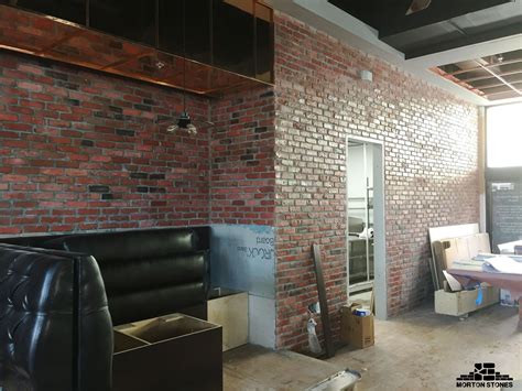 This is one of our best red brick veneer wall projects. #mortonstones #brick #brickwall #rust ...