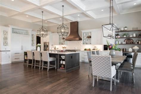 Large dine-in kitchen featuring a white coffered ceiling matching the white cabinetry and ...