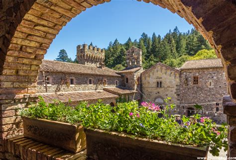 Castello Di Amorosa, Napa Valley - Beautiful flowers inside a brick archway overlooking the ...