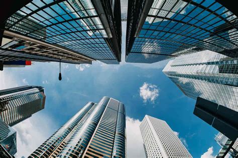 Download A View Of Skyscrapers From A Circular Window | Wallpapers.com