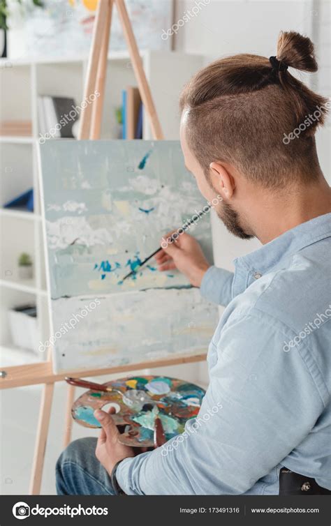 Man painting on canvas — Stock Photo © IgorVetushko #173491316